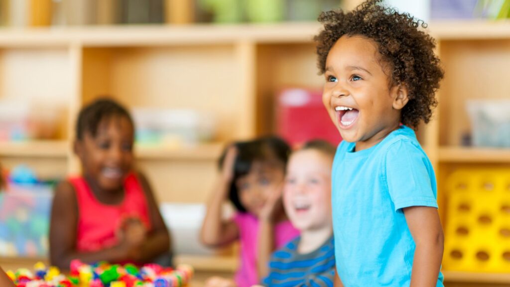 a child laughing in a classroom