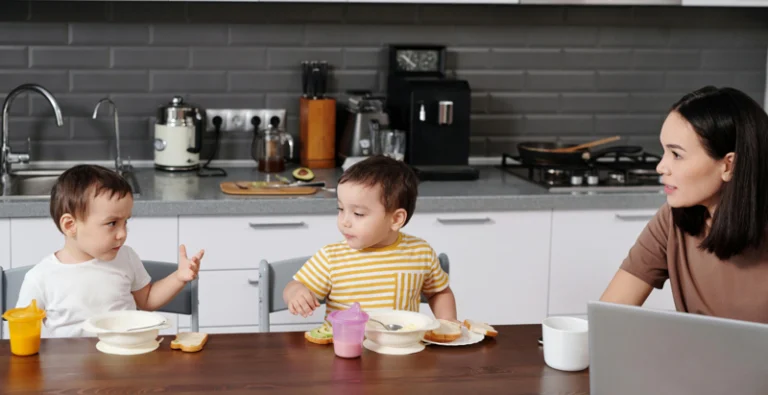 children at a table with their mother