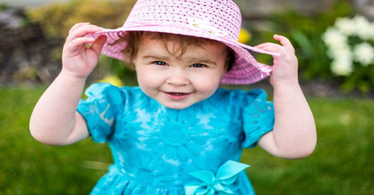 a little girl with a hat