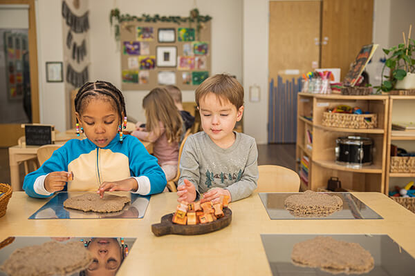 Male toddler wearing a crown and eating a piece of cake