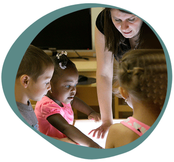 a teacher with students at one of our daycares