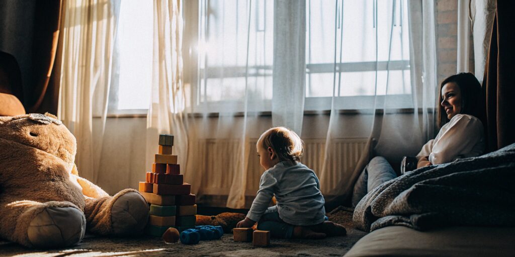 A child and parent exploring the learning through play curriculum with building blocks.