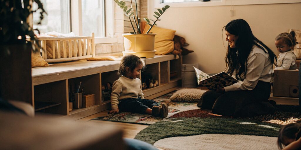A teacher reads to a group of 3-year-olds in a preschool program.