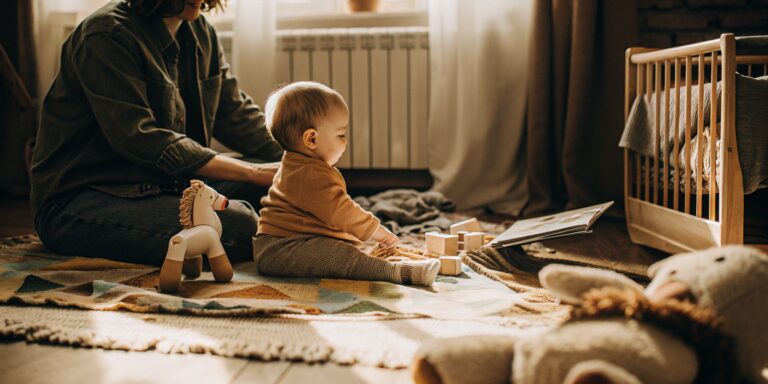 An infant engaged in a learning project with wooden blocks.