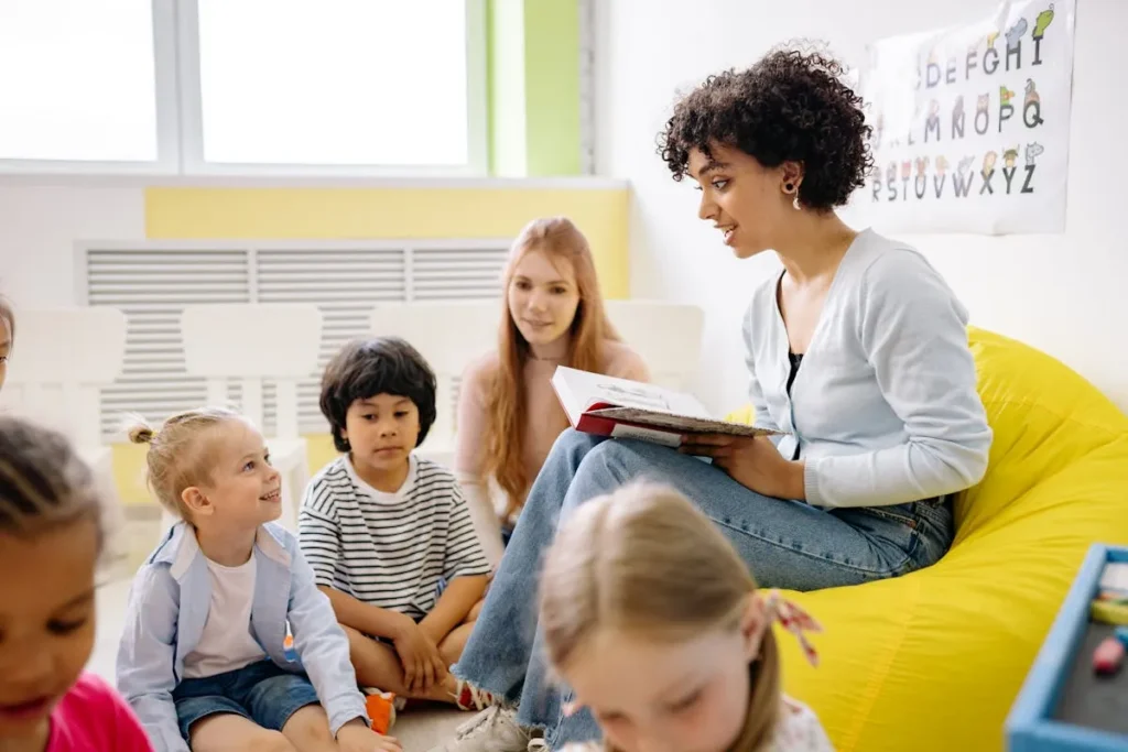 Two-year-old toddler stacking colorful blocks in an early childhood classroom