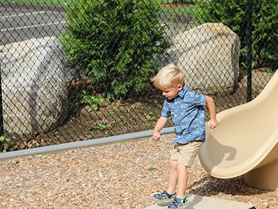 a child stepping off one of our slides