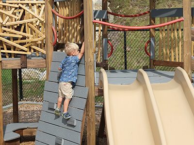 a child playing on one of our playgrounds